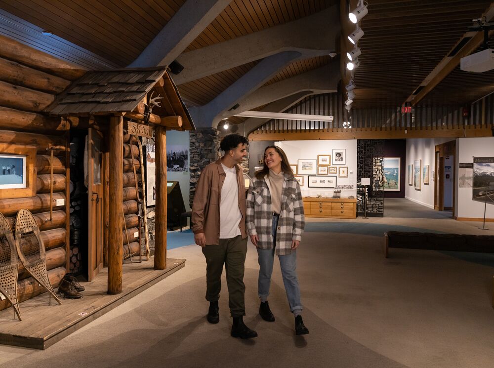 Two people walk through the Whyte Museum of the Canadian Rockies.